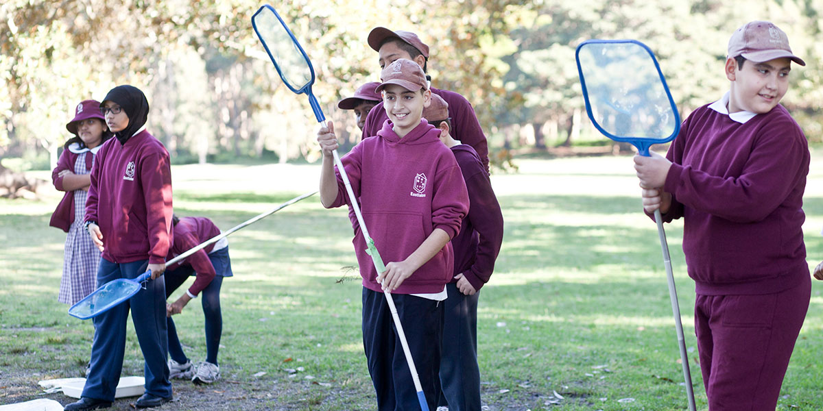 School children picking up rubbish in parklands