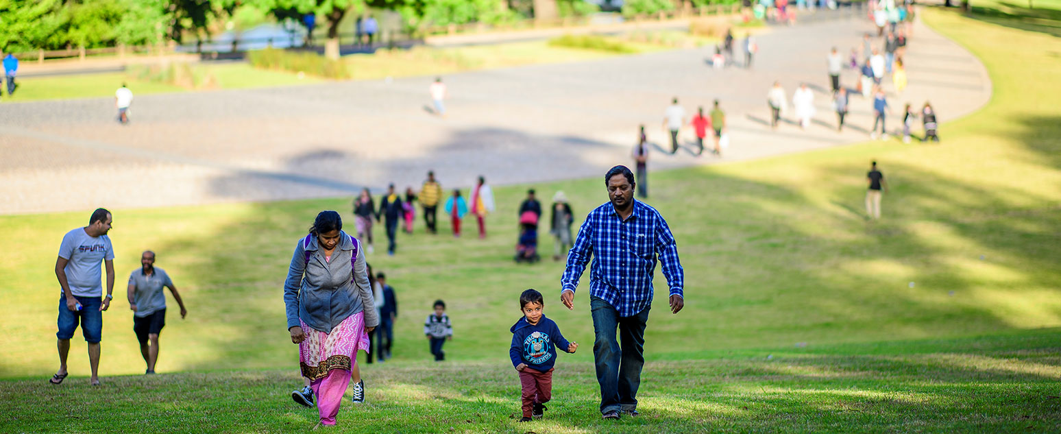 People walking up a hill in a park