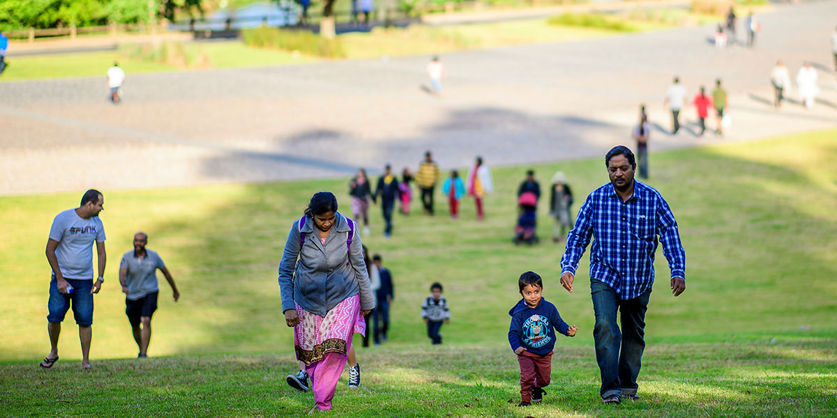 People walking up a hill in a park