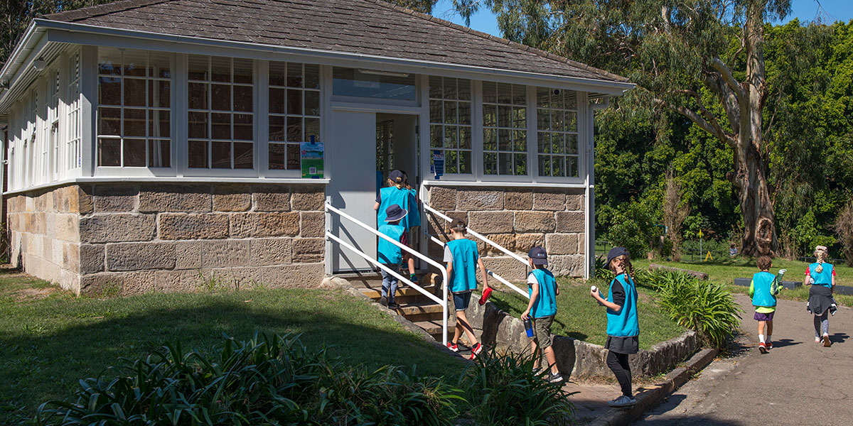 School children running up stairs of heritage building