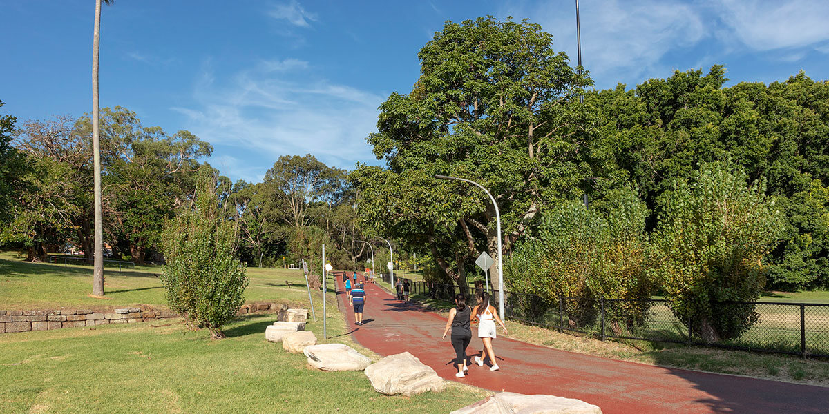 Women walking thru park
