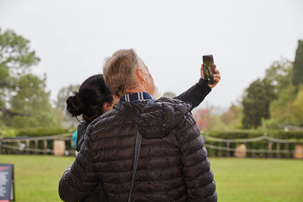 Man and woman taking selfie in park