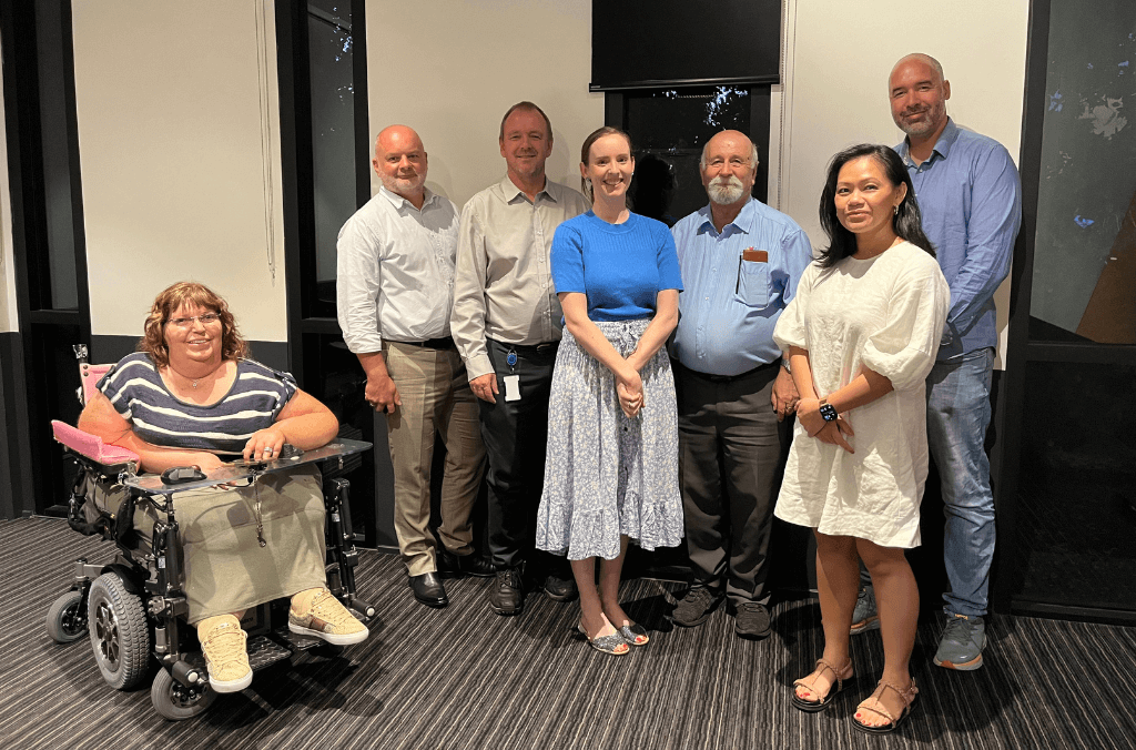 Western Sydney Parklands community trustee board members pose for a photograph in an indoor meeting room