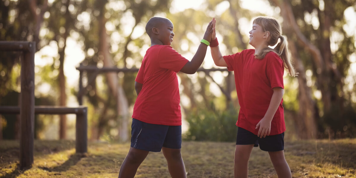 Two school kids high fiving eachother