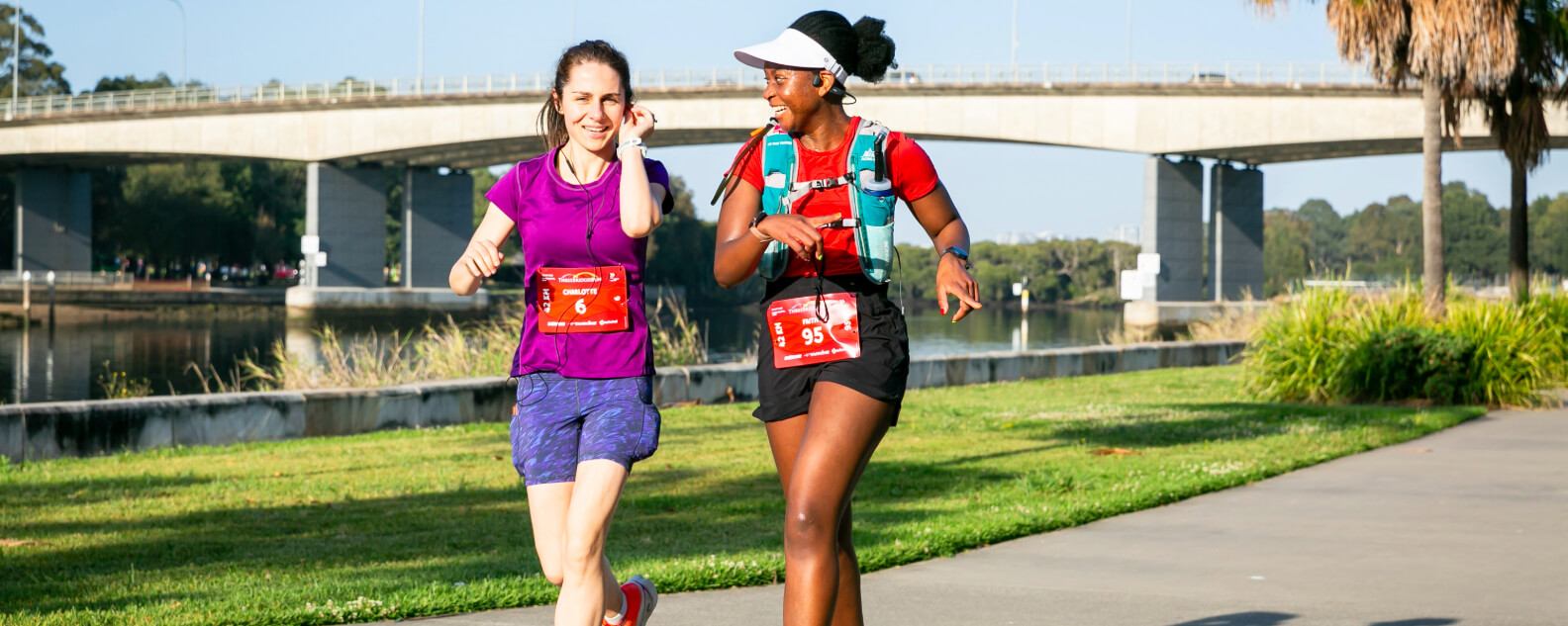Two ladies running and smiling together