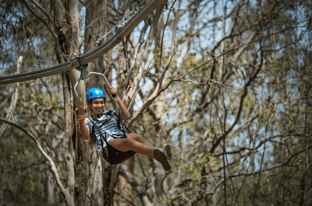 Woman on zipcoaster at Treetops Adventure Western Sydney.