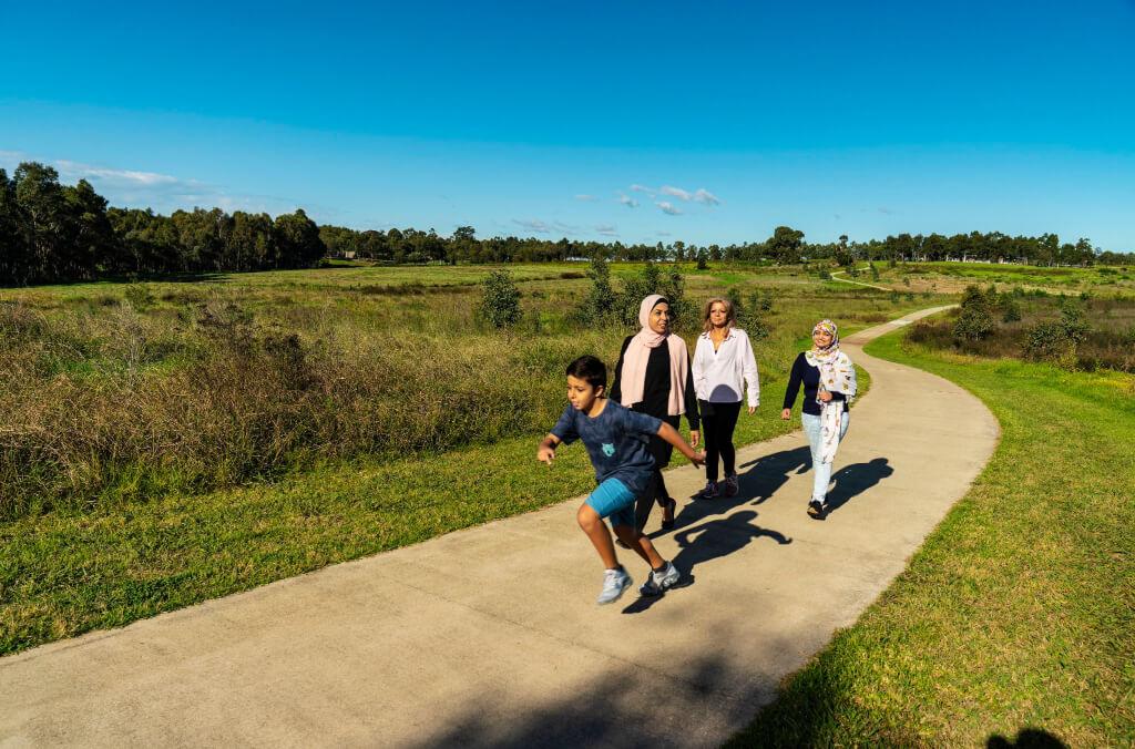 A family enjoying the Moonrise Loop walk with The Dairy in the background.
